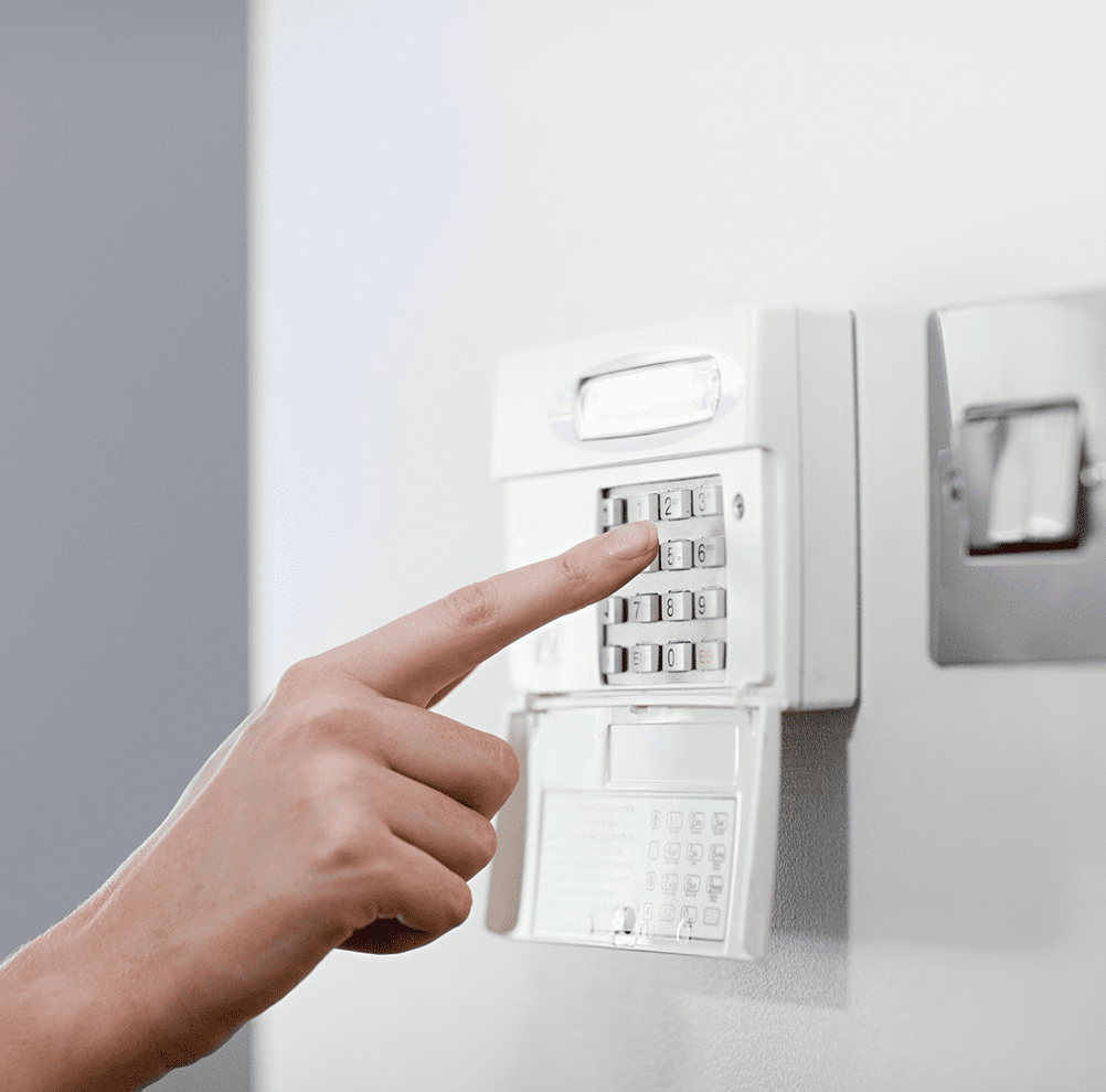 Hand entering code on security keypad.