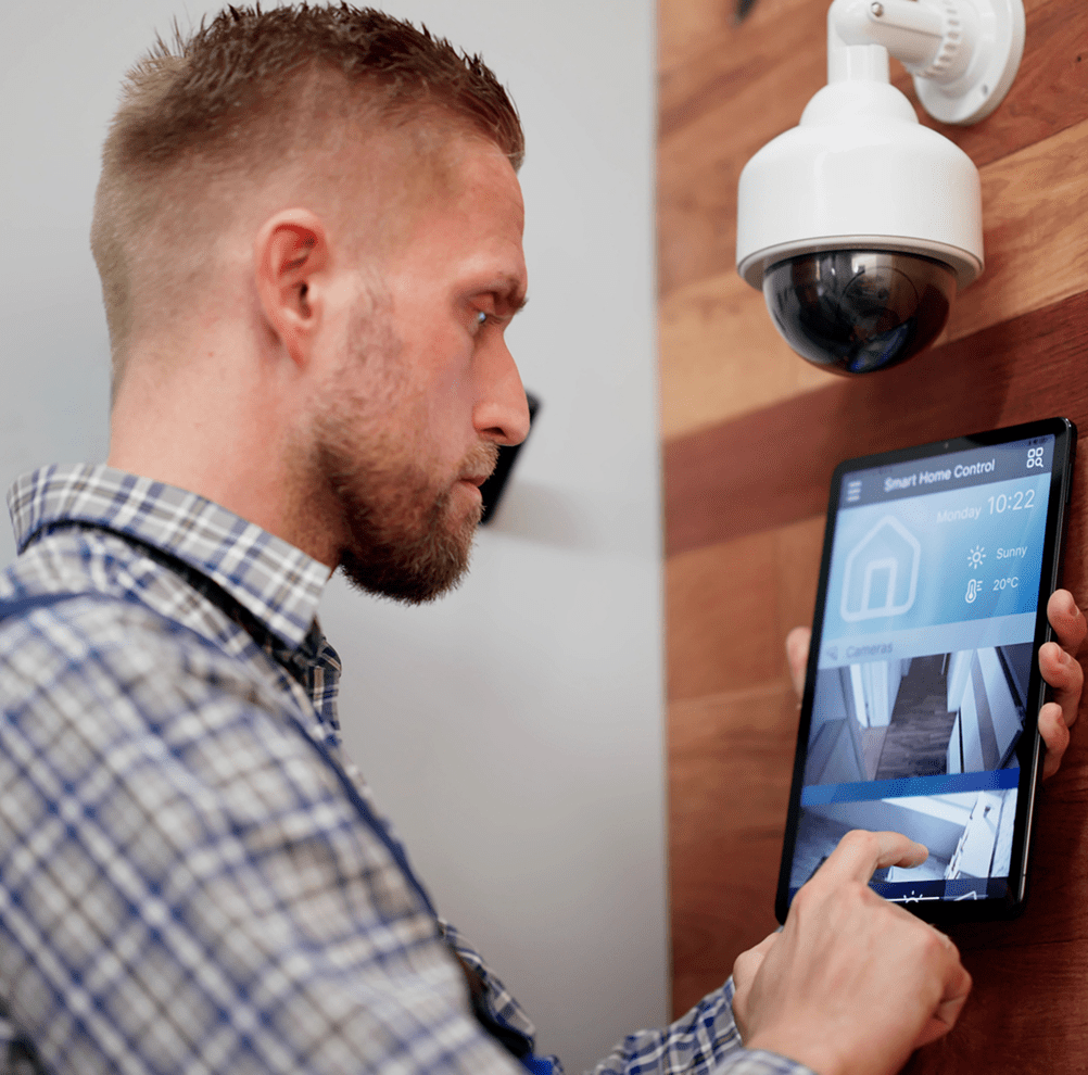 Man using tablet for smart home control.